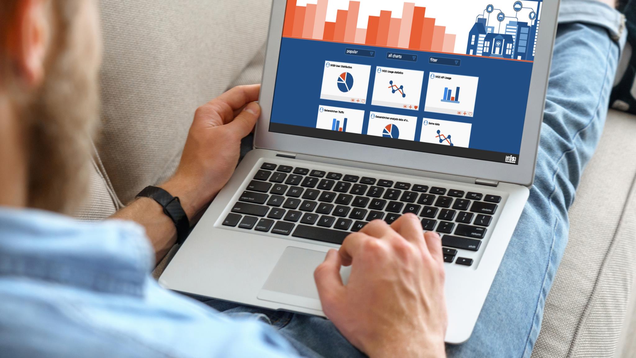 Mann sitzt mit Laptop auf dem Sofa